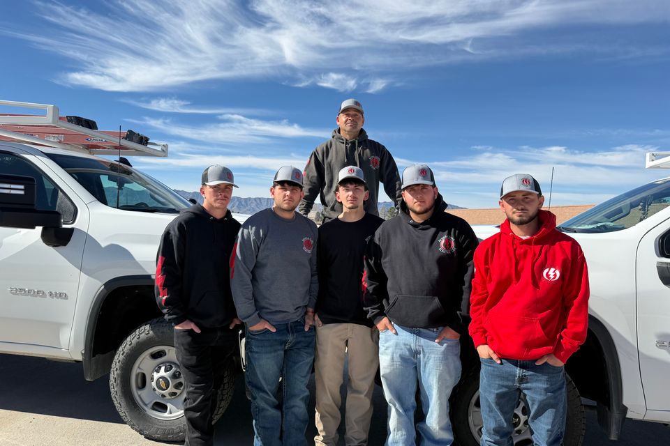 The Avena & Sons Electric crew standing in front of their service trucks